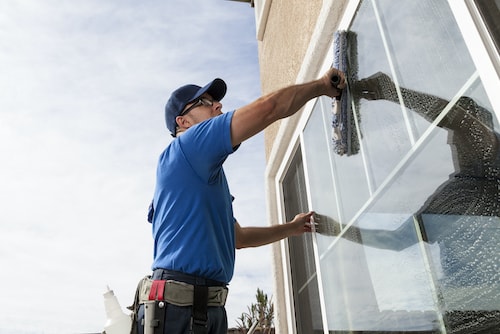 old man cleans window 500